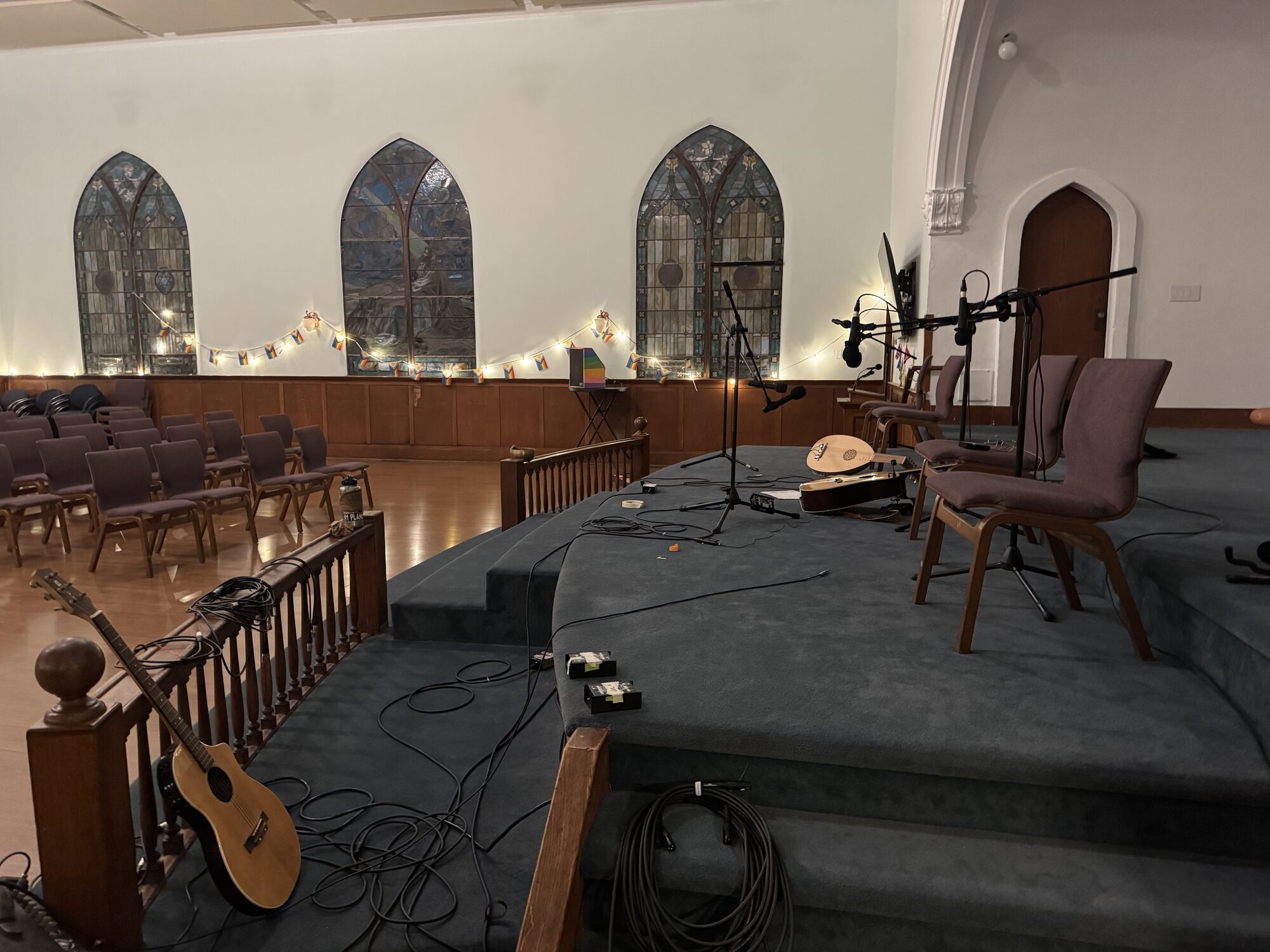 Main-room stage prepared with microphones for a recorded performance